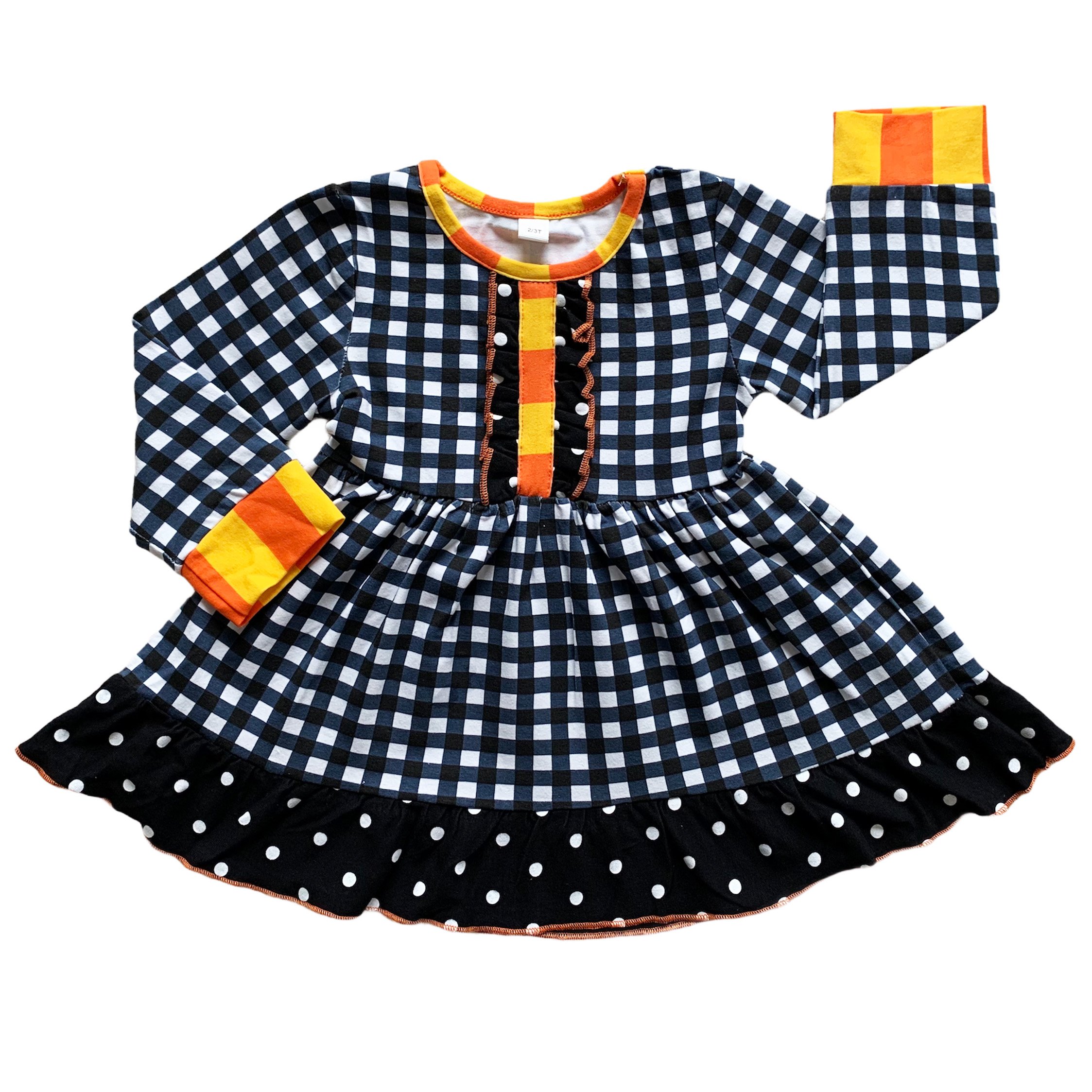 AnnLoren Girls Autumn outfit featuring a black and white gingham dress with polka dot ruffle trim and black leggings with ruffle trim.